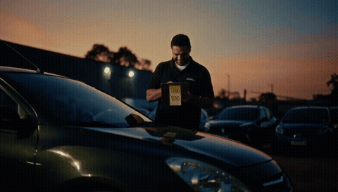 Lojista inspecionando carro para comprar bem